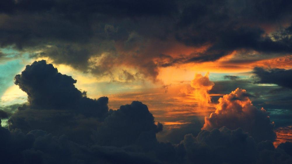 Golden Sunset Amidst the Stormy Clouds wallpaper