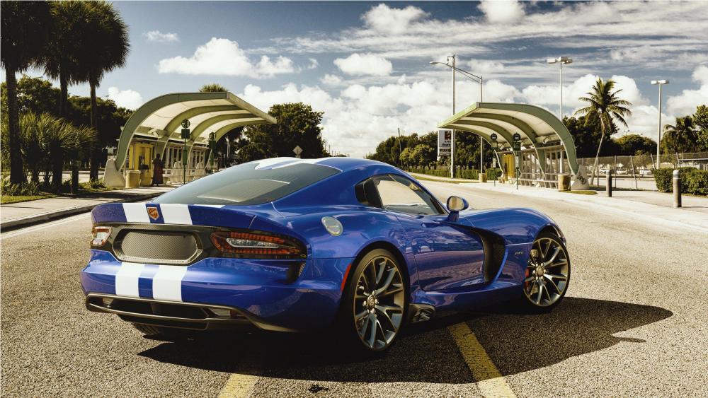 Sleek Blue Dodge Viper Sports Car Under Sunny Skies wallpaper