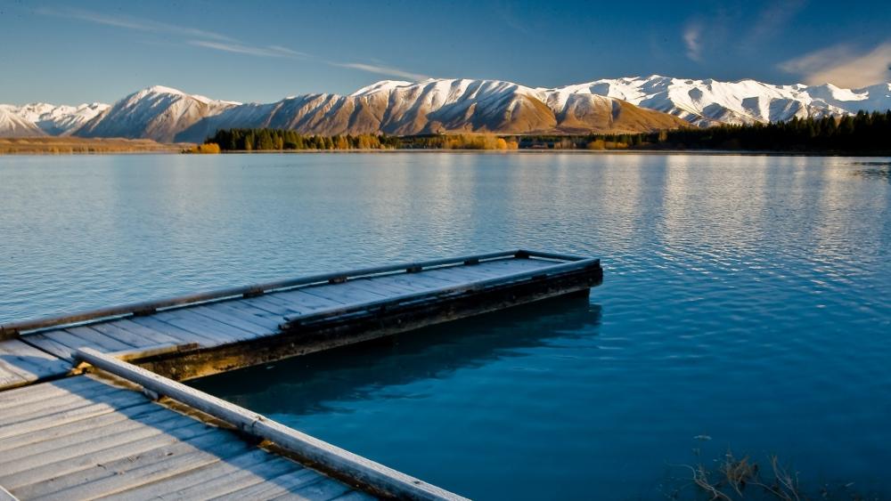 Serene Lakefront With Snow-Capped Mountains wallpaper