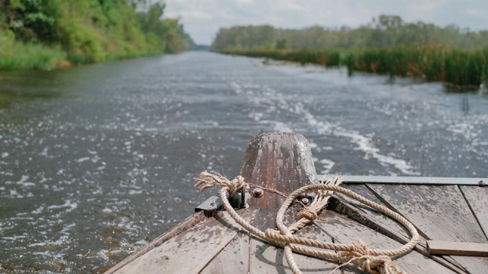 Rustic Boat Journey Through Natural Waterways wallpaper