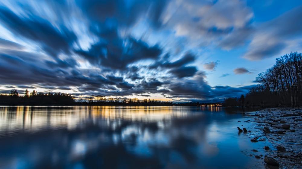 Sweeping Skies Over Tranquil Waters wallpaper