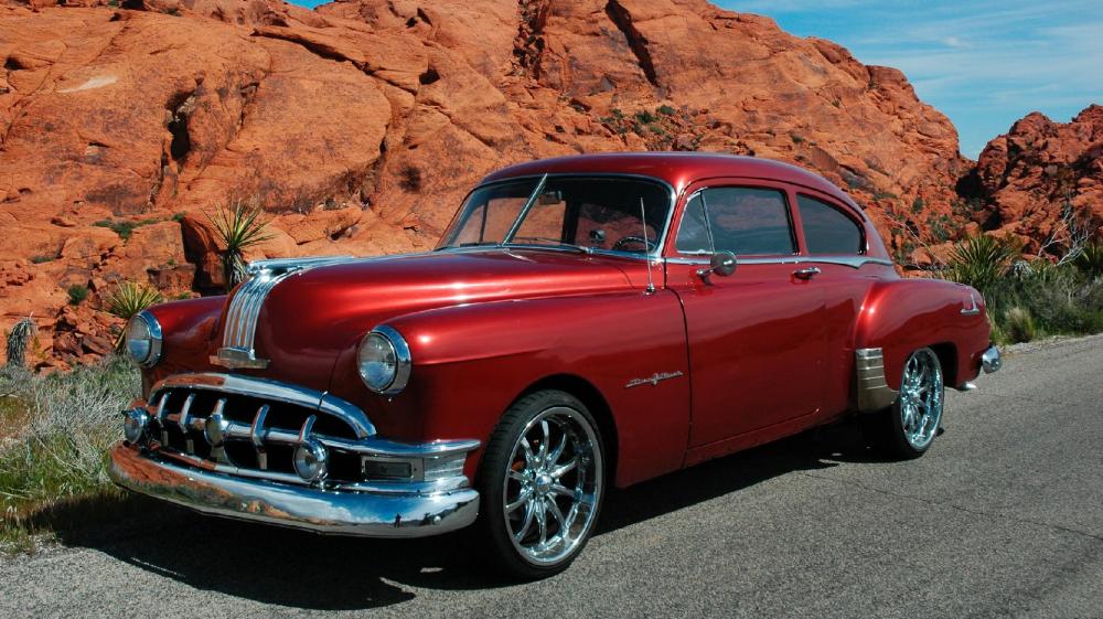 Vintage Red Classic Car on Desert Road wallpaper