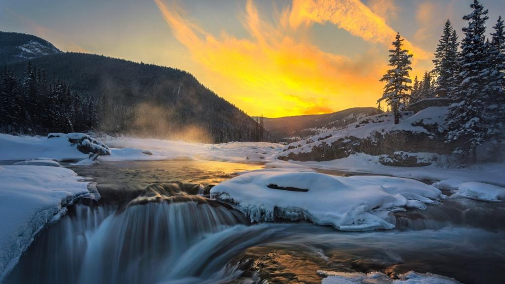 Golden Sunset Over a Wintry Waterfall wallpaper