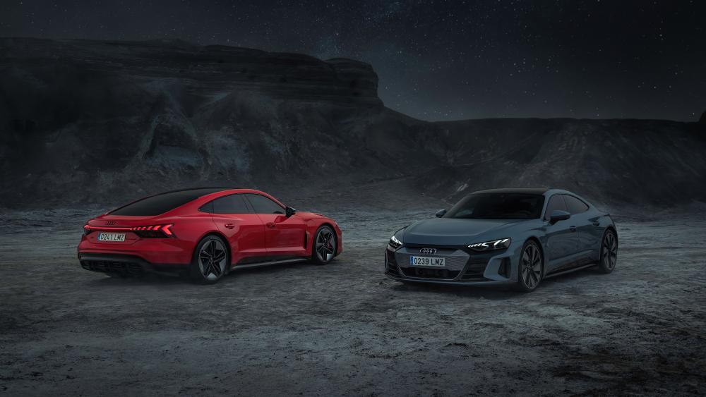 Nighttime Showdown of Sleek Sports Cars wallpaper