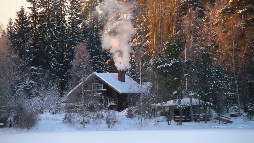 Winter Cabin Retreat Amidst Snowy Tranquility wallpaper