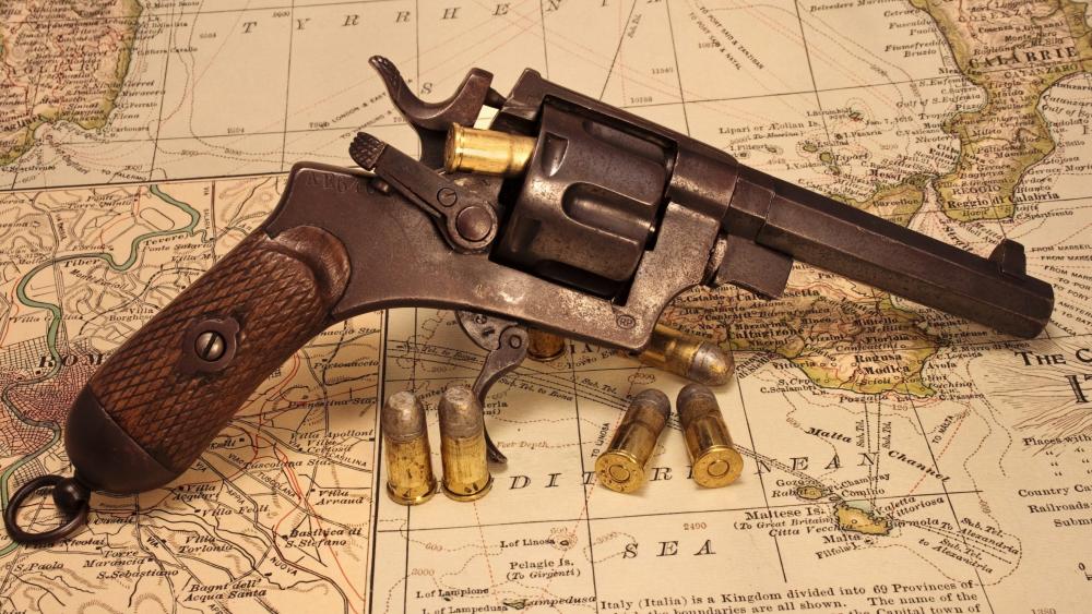 Vintage Revolver on Antique World Map wallpaper