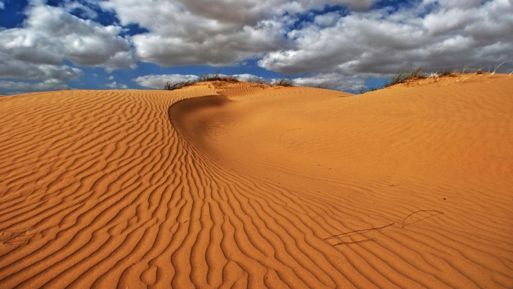 Desert Dunes Under a Dynamic Sky wallpaper