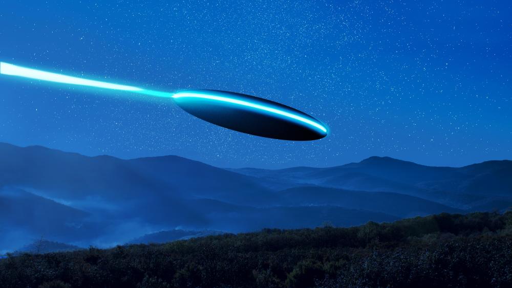Mysterious UFO Sighting Over Misty Mountains wallpaper