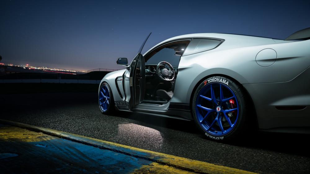 Sleek Ford Mustang Under Night Sky wallpaper