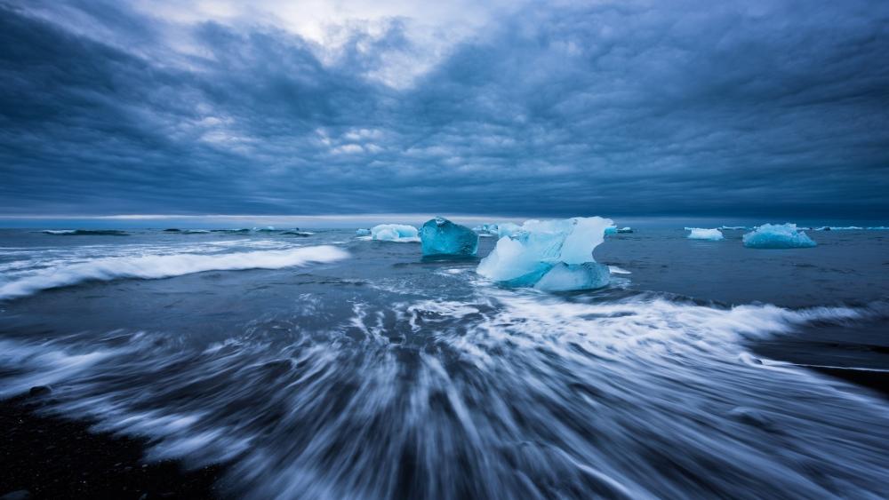 Mystic Arctic Blues Amidst Turbulent Waves wallpaper