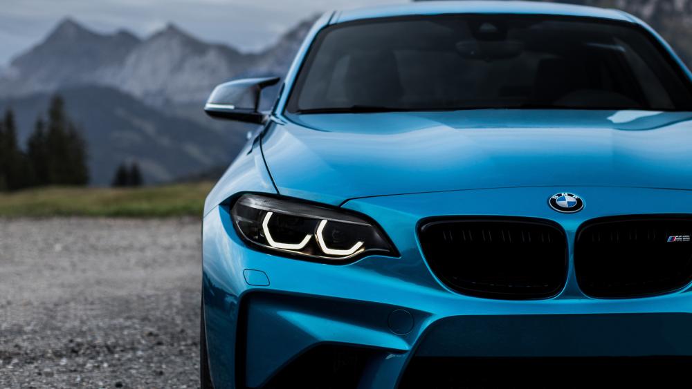 Sleek Blue BMW M2 Against Mountain Backdrop wallpaper