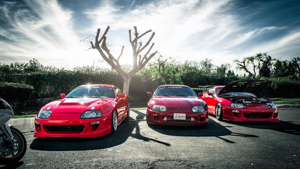 Gleaming Trio of Red Toyota Supras wallpaper