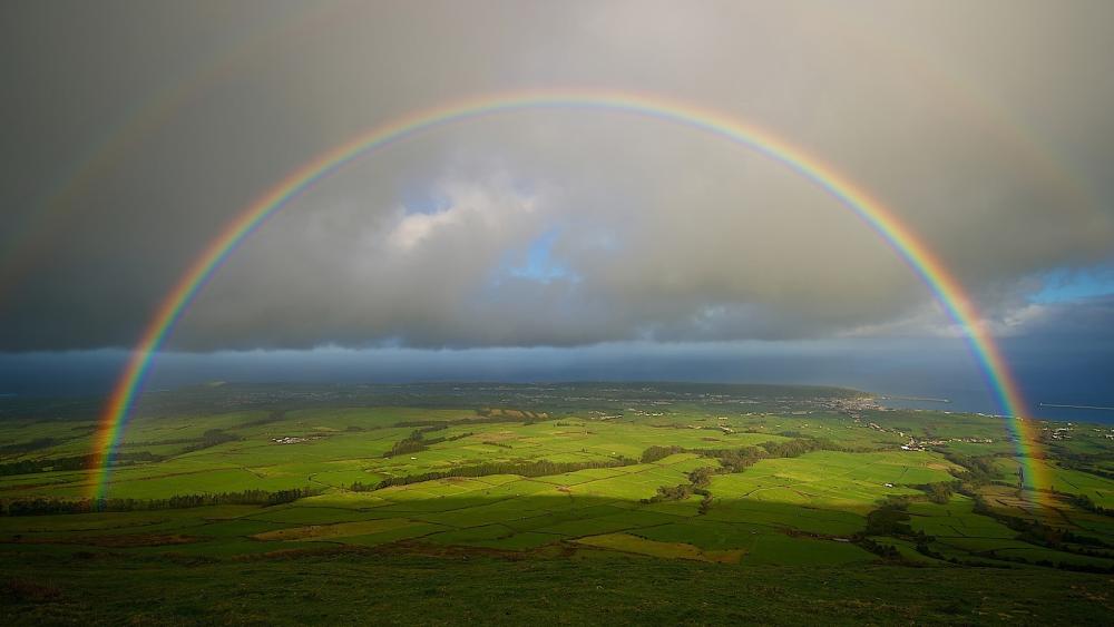 Rainbow Over Lush Landscape wallpaper