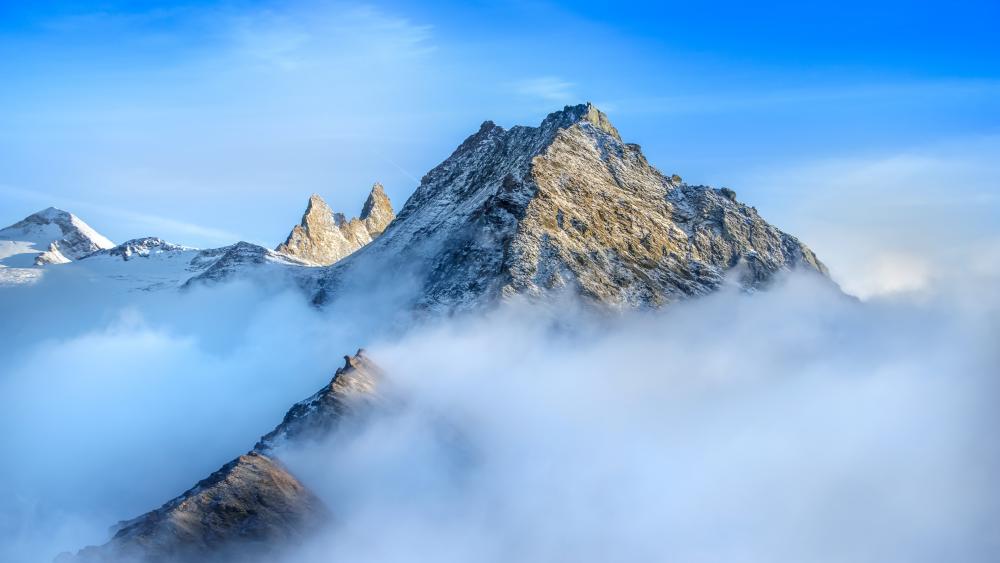 Majestic Alpine Peaks in the Clouds wallpaper