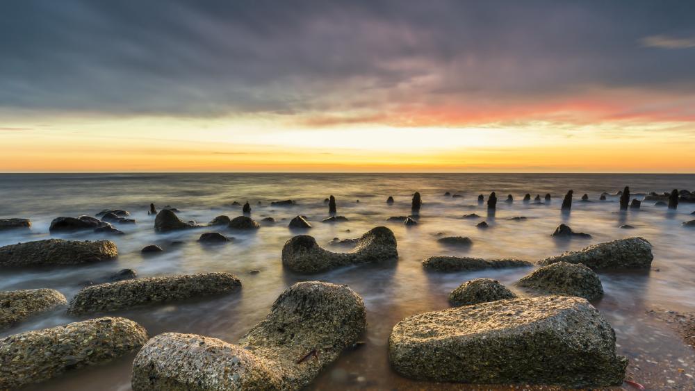 Tranquil Horizon Over Seaside Stones wallpaper