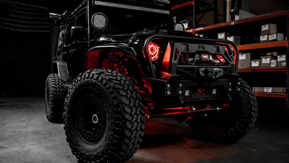 Rugged Jeep Monster Truck in a Warehouse wallpaper