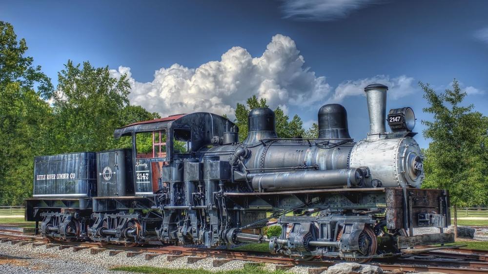 Historic Steam Locomotive Displayed Outdoors wallpaper