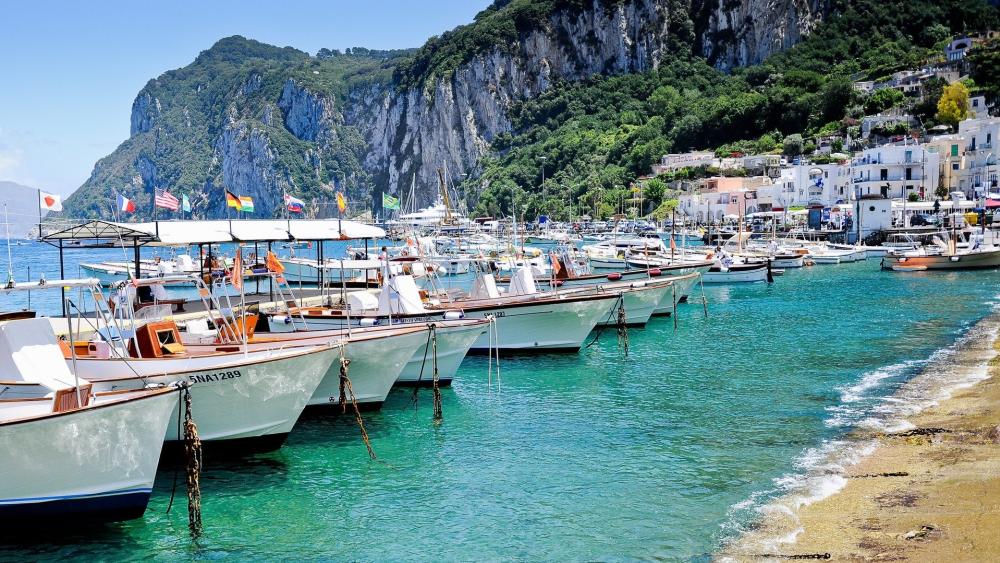 Capri's Scenic Dock with Motorboats wallpaper