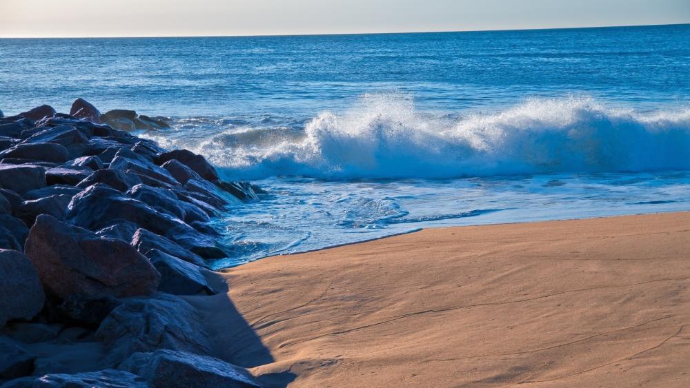 Wave Splash on Serene Sandy Shore wallpaper