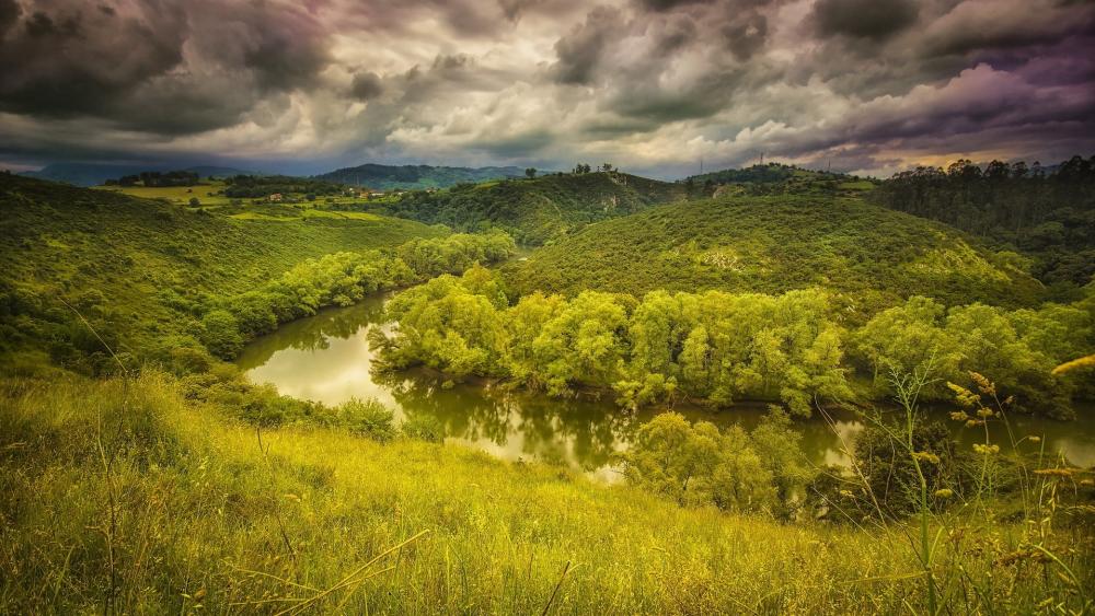 Curved River Under Cloudy Skies wallpaper