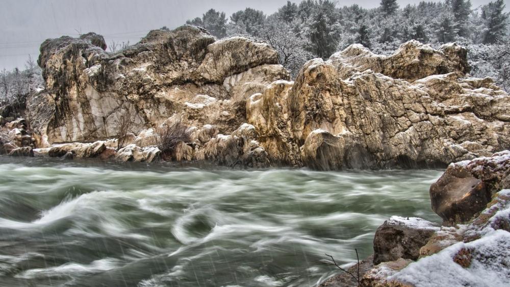 Winter River Flowing Through Rocky Landscape wallpaper