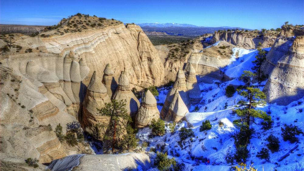 Majestic Rock Formations and Snowy Peaks wallpaper