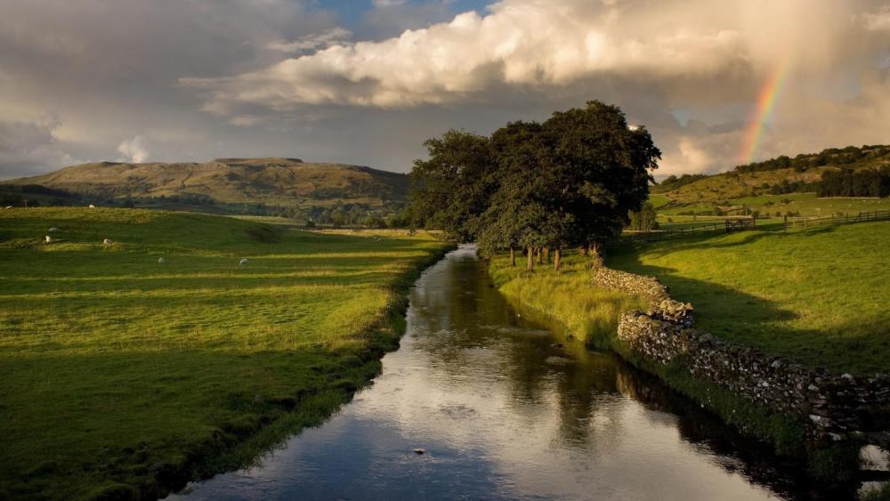 Rainbow over Lush Canal Landscape wallpaper