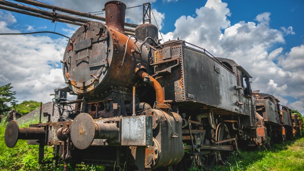 Abandoned Rusty Train Under Blue Sky wallpaper