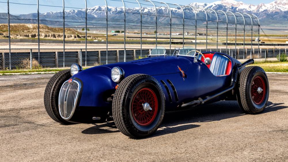 Vintage Blue Roadster in Scenic Background wallpaper