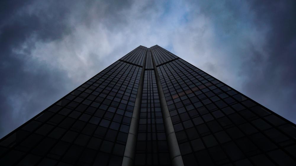 Soaring Skyscraper under Moody Skies wallpaper