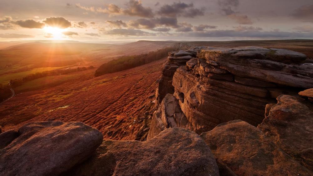 Majestic Sunset Over Rocky Terrain wallpaper