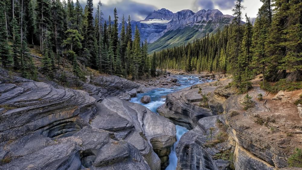 Mountain Serenity with River and Rocks wallpaper