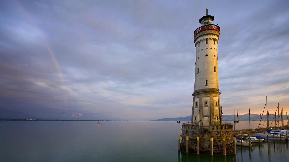 Lighthouse Against a Serene Sunset Sky wallpaper