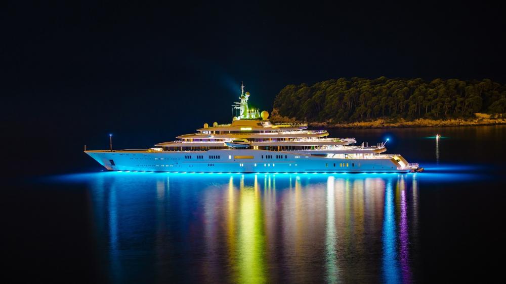 Majestic Yacht Illuminated at Night wallpaper