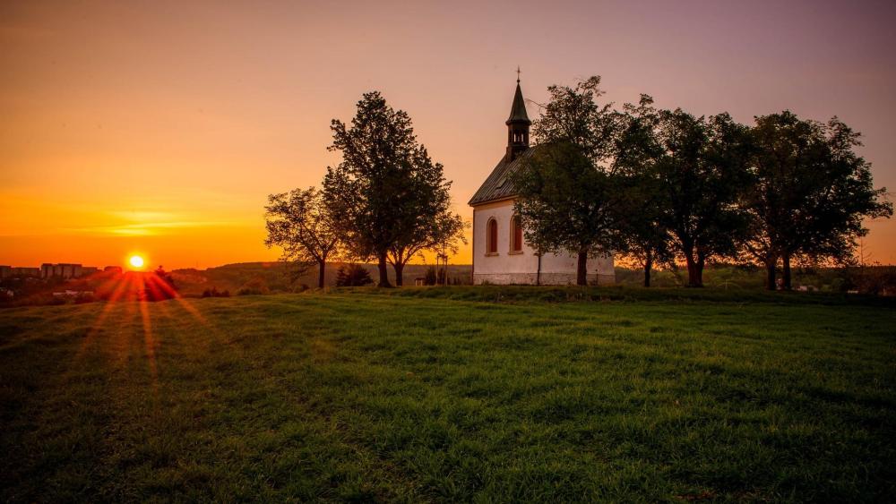 Serene Sunset Over a Tranquil Chapel wallpaper