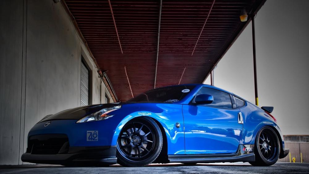 Nissan 370Z Blue Beauty in Industrial Setting wallpaper