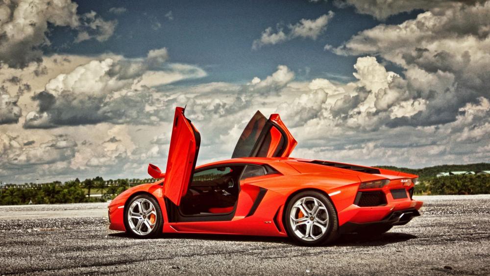 Lamborghini Aventador in Motion Against Dramatic Clouds wallpaper