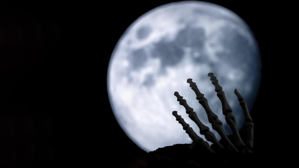 Skeleton Hand Reaches for the Moon’s Light wallpaper