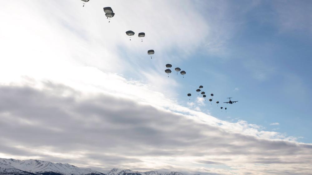 Parachuting Over Snowy Peaks: Elite Forces in Action wallpaper