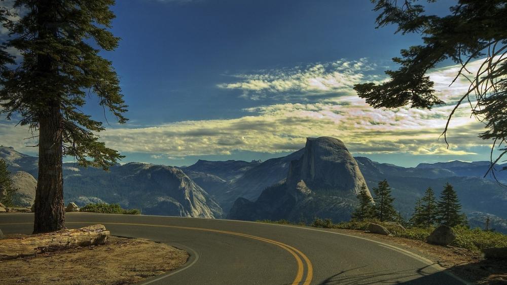 Curving Roads Lead to Majestic Peaks wallpaper