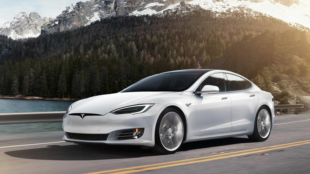 Tesla Model S Driving by Scenic Mountains wallpaper