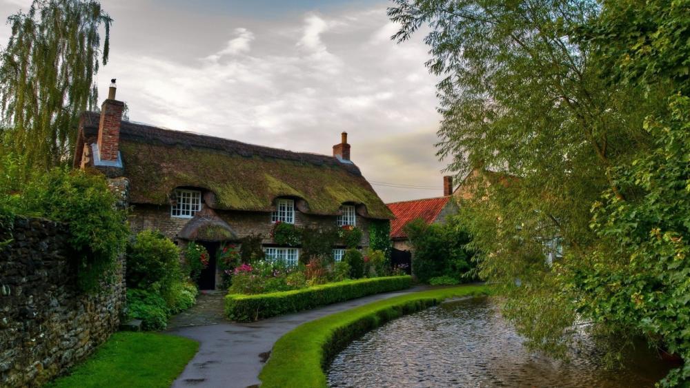 Quaint Countryside Cottage by a Serene Pond wallpaper