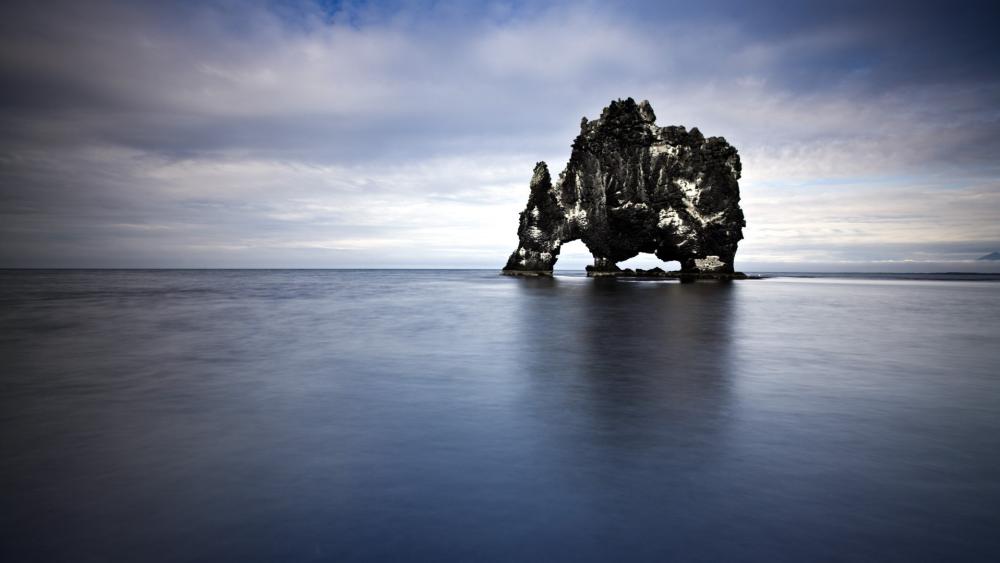 Hvítserkur Sea Stack Under Vast Sky in Iceland's Wilderness wallpaper