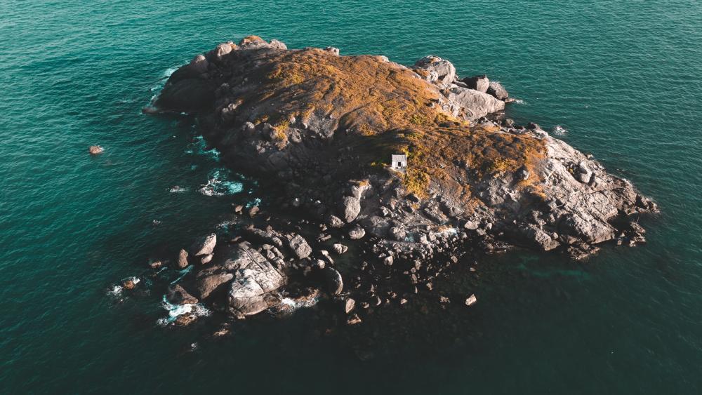 Rocky Haven Amidst Azure Waves wallpaper
