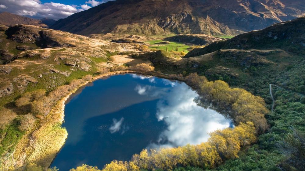 Heart-Shaped Lake with Stunning Reflections wallpaper