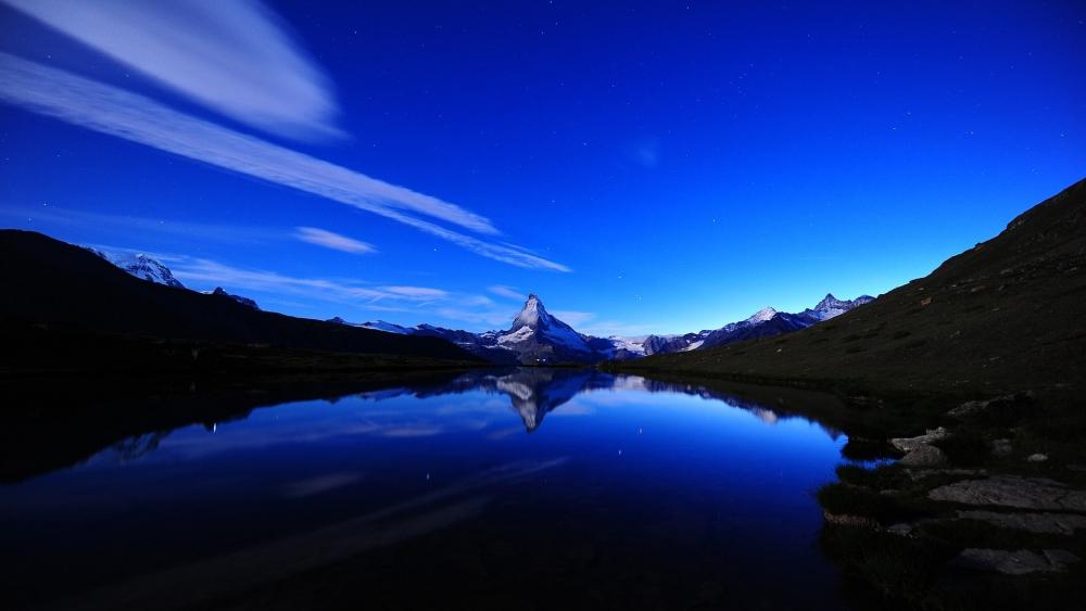 Starlit Reflections at Stellisee Lake in the Alps wallpaper