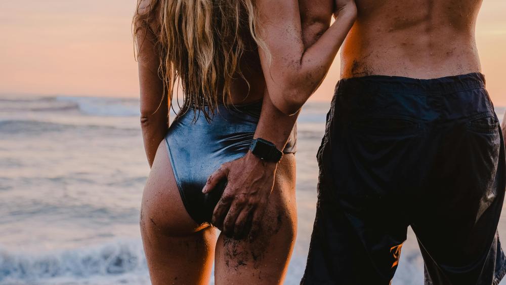 Romantic Beach Sunset with Couple in Love wallpaper