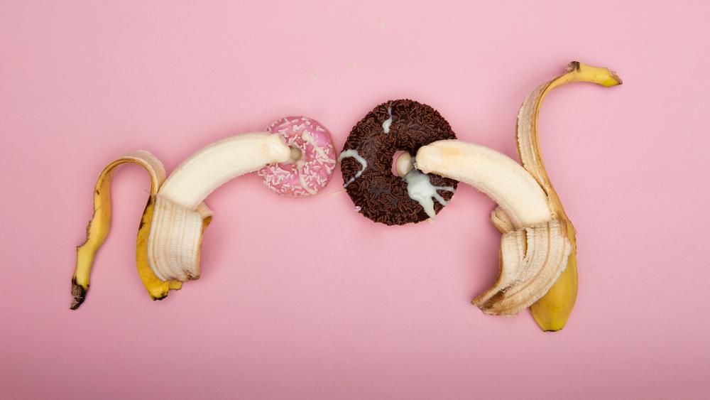 Banana Doughnut Fun on Pink Background wallpaper