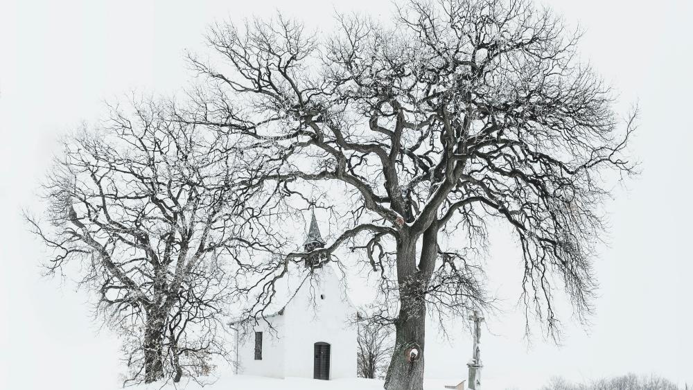 Winter's Silent Embrace: Snow-covered Church in Black and White wallpaper