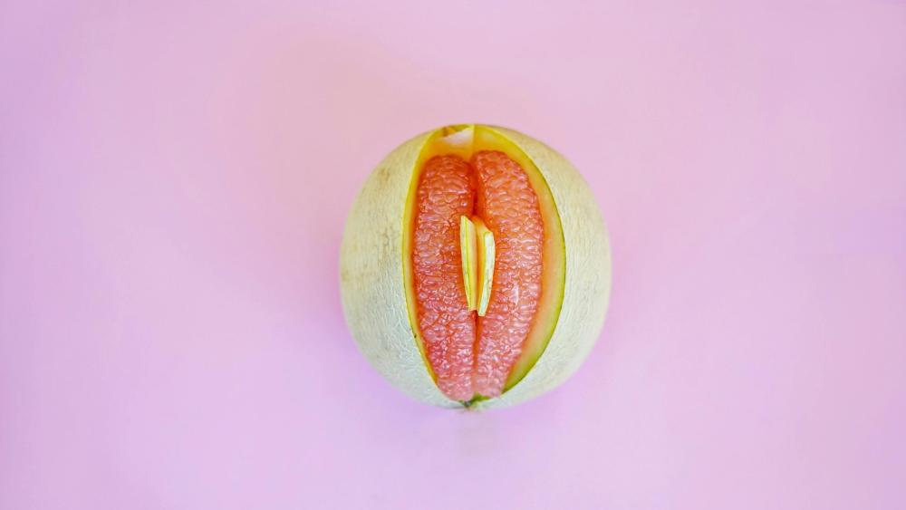 Juicy Melon with a Playful Twist on a Pink Background wallpaper